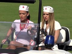 Watch these horny babes dressed as nurses having a threesome with a guy on top of a golf cart outdoors as you hear them moan.