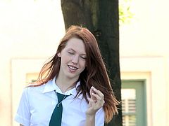 Lacie is the slim redhead babe in a school uniform. She reads some book. Her skirt is so short that you can see her white panties. This babe gets horny so, she lifts the skirt up to show her teen pussy.