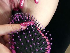 Rapacious blond haired filth pokes her tight vag with big comb