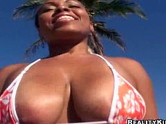 Be part of this clip where an ebony lady, with gigantic boobs wearing a bikini, gets covered in oil and gets banged hard by a white dude.