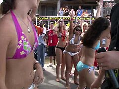 I guess this is a bikini contest or something? Hot chicks in bikini and crowd watching. Check it out right here, dickbutt!