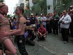 Have a good time watching these homosexuals, with yummy asses wearing leather clothes, while they torture each other in the middle of the street.