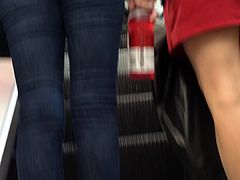 Denim jeans ass going up the escalator