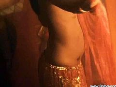 This Indian chick is quite a beauty. She dances in traditional clothes and she reveals her breasts and bare back. She moves her hips in a very sensual manner.