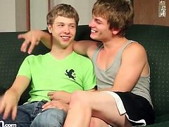 Two super cute twink gay boys kiss on the couch