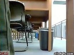 Pretty girl with small tits goes kinky in a public library. She flashes her tits while nobody sees her. She also slides her hand under her skirt. She fondles her coochie upskirt.