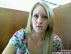 Sexy girl is chatting on webcam while sitting in a public library. She exposes her smoothly shaved pussy for camera upskirt. She appears to be not wearing any underwear.