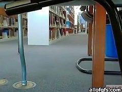 Sexy girl is chatting on webcam while sitting in a public library. She exposes her smoothly shaved pussy for camera upskirt. She appears to be not wearing any underwear.