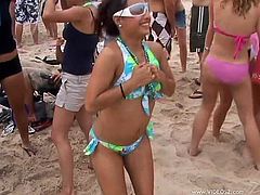 Get a boner by watching these wild chicks, with natural breasts wearing bikinis, while they show their boobs outdoors in a crazy party.