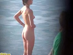 A dude films a slim blonde on a nudist beach. She gets in the water, sunbathes and puts sunscreen all over her body. Her tits are perky and her ass is nice too.