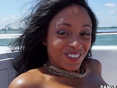 Ebony beauty Anya Ivy demonstrates her big natural tits and clean pussy as she enjoys the sun totally naked on a boat. Then she gets her mouth filled with hard dick. She sucks that cock with her sexy ass up.