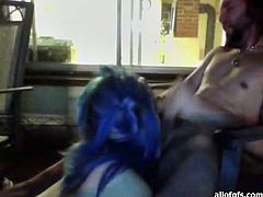 Horny dude squeezes big boobs of skanky blue haired chick. He then thrusts big dick in her mouth. Dirty slut sucks the rod taking it deep up her throat.