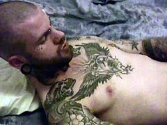 Tattoeed stud with random piercing on his body getting horny as he took his huge dick stroke it and jacking it off til he releases her fresh hot load right on his body.