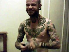 Tattoeed stud with random piercing on his body getting horny as he took his huge dick stroke it and jacking it off til he releases her fresh hot load right on his body.