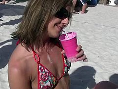 These smoldering hot drunk girls are having a blast partying in their tiny bikinis at the beach while downing shots and getting wasted.