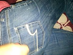 Woman jerking off man on her jeans