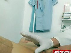 This busty redhead has her boobs measured by her gynecologist and her pussy examined with a speculum. She listens to his instructions carefully and obliges.