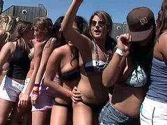 Gorgeous ladies with natural tits and colorful attires dancing passionately in a bikini party outdoor while displaying their hot ass