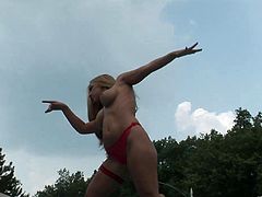 Curvy blonde gives a performance at an outdoor party