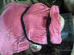 Innocent slave Mona is tied to the floor with a pink rag over her face so she can't see what is going to be done to her. The master canes her body and then uses a vibrators on her cunt. The combination of pain and pleasure is appealing to her.