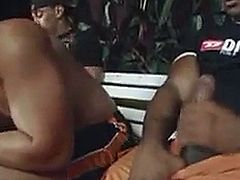 Muscular hunks of different races having a threesome on a bench