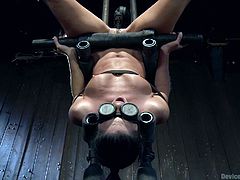 India is a nasty milf and she is confined in a bondage device, that has her upside down with a phallic object, being shoved into her wet cunt. Her eyes are covered, so she can't see, as the device is plunged into her vagina.