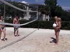 Amber Bach, Charlee Chase and Melanie Hicks meet Scott at the beach. They decide to treat him with a handjob, so they go indoors where they stroke his cock and tease him with their huge boobs.