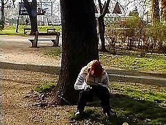 Woman writing in a tree in the park
