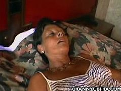 Granny Karen arrives home and lays down on her bed. She starts caressing her boobs over her top and her pussy over her panties. She has a pair of sexy stockings on.