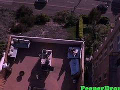 Jennifer White and her lover was in the rooftop and they are naked and fucking under the heat of the sun. This cool drone caught them doing that and they don't give a fuck.