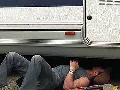 2 males repairing a car