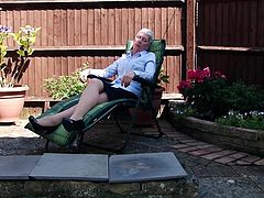 54 year old Fleur has just got home from the office and she is going to relax in her backyard. She sits on her lounge chair and opens her top a little bit, to reveal her massive breasts. The mature slut shows off her sexy pantyhose, too.