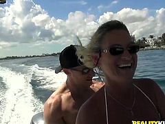 This sexy milf gets picked up and she goes out on the boat with her man. They do some fishing and she shows off her sexy body. She reveals her huge breasts and sunbathes naked. She is ready to suck him off now.