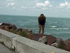 The woman sat down on the rocks pissing