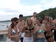 Bold bikini chicks on a boat take off their tops and flash titties