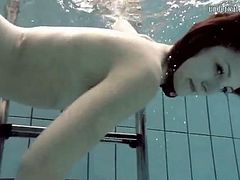 Skinny girl looks sexy as she goes swimming nude