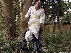 Her head is wrapped and her kimono is ripped open, so her master can use her like a sex slave in the woods. She is humiliated and has a hole in her hood. Watch as she sucks him off, before being bent over, to get fucked hard.