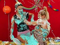 Food fight calls many things to memory, like two hot babes at a table full of desserts. The pair of ladies then smear each other all over with the selection of whipped cream and icing-heavy sweets. Then they wrestle each other.