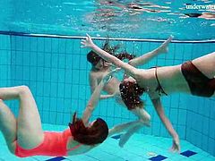 Three teen friends strip in the swimming pool