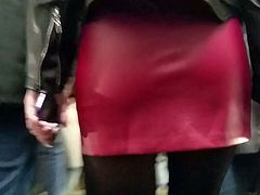 Sexy brunete's ass in red leather skirt