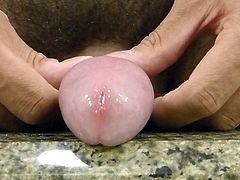 Pissing closeup with foreskin pulled back cockhead pee hole