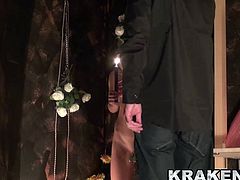 Sweet blonde girl plays with a candle in a BDSM scene