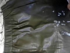 Cumshot on a green leather skirt