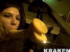 Naughty girl in public scene sucking a dildo in the car