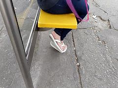 Candid cute girl feet on bus stop