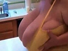 Mature blonde plays with her massive tits