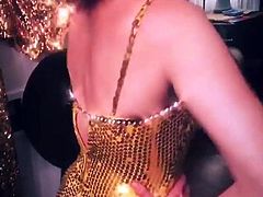 Milana Vayntrub showing epic cleavage in golden dress