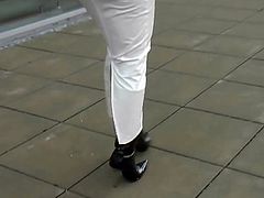 Car driving in white hobble skirt and high heels