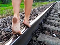 Beautiful feet on dirty railway get dirty...