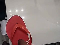 Friend having fun with his moms Maria flip flops at home